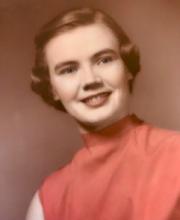 An old photograph of a woman with bobbed hair and an orange mock-neck shirt.